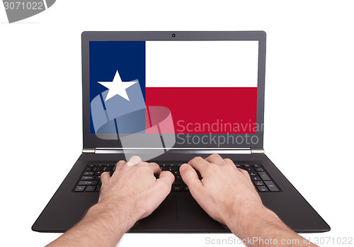 Image of Hands working on laptop, Texas