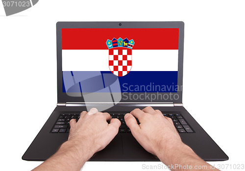 Image of Hands working on laptop, Croatia