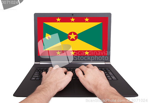 Image of Hands working on laptop, Grenada