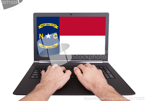 Image of Hands working on laptop, North Carolina