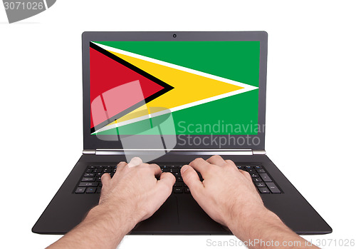 Image of Hands working on laptop, Guyana