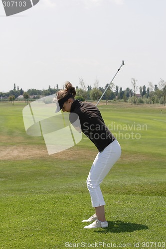 Image of Female golfer playing golf