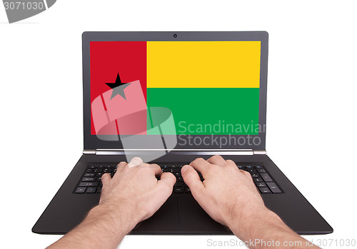 Image of Hands working on laptop, Guinea-Bissau