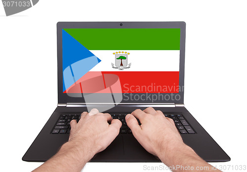 Image of Hands working on laptop, Equatorial Guinea