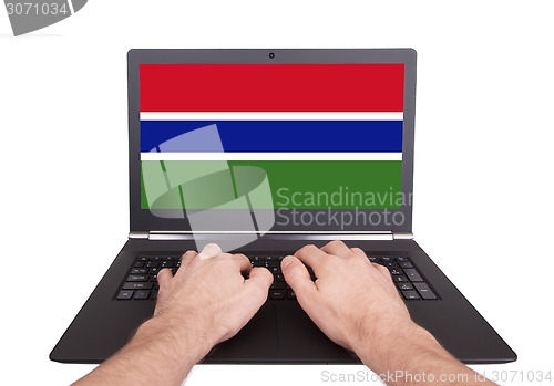 Image of Hands working on laptop, Gambia