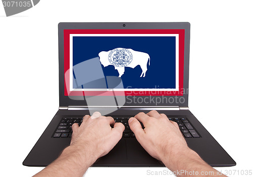 Image of Hands working on laptop, Wyoming