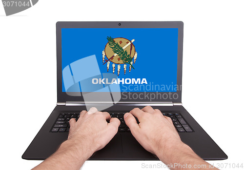 Image of Hands working on laptop, Oklahoma