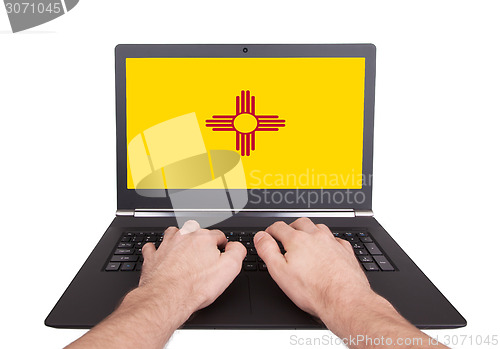 Image of Hands working on laptop, New Mexico