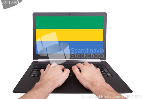 Image of Hands working on laptop, Gabon