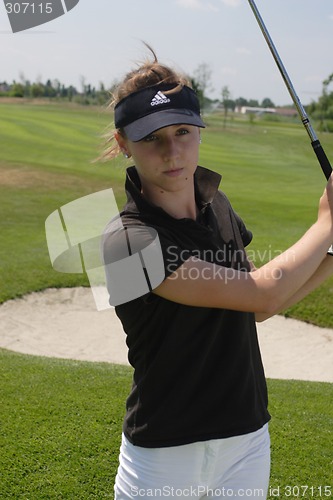 Image of Female golfer playing golf