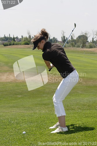 Image of Female golfer playing