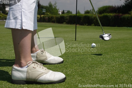 Image of Female golfer playing