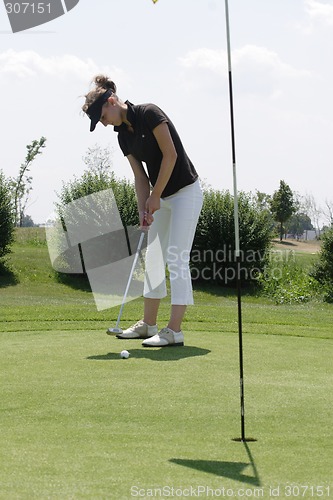 Image of Female golfer playing