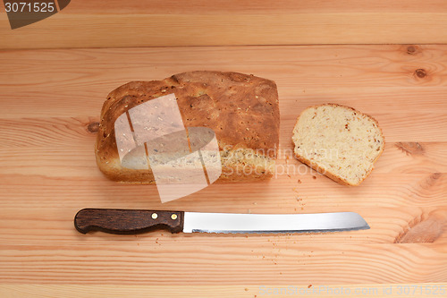 Image of Fresh loaf of bread with a cut slice