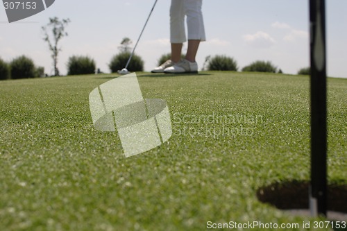 Image of Female golfer playing