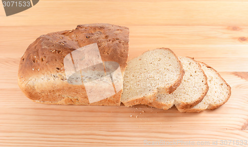 Image of Crusty loaf of fresh bread and three slices