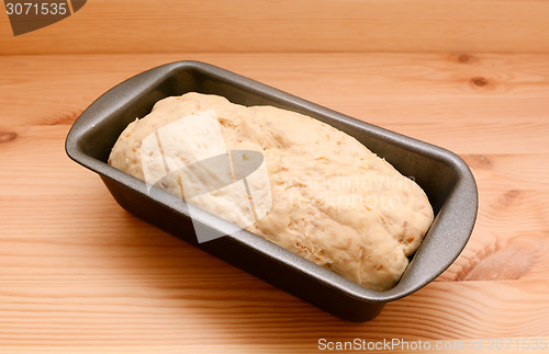 Image of Raw bread dough in a 2 lb loaf tin