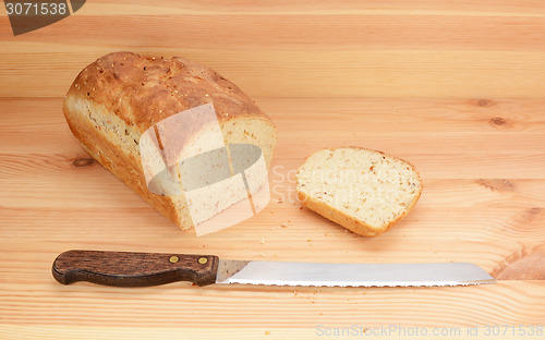 Image of Bread knife with freshly sliced loaf of bread 