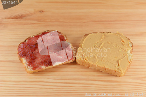 Image of Slices of fresh bread with jelly and peanut butter