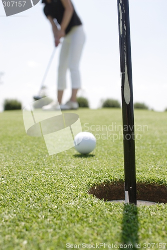 Image of Female golfer playing