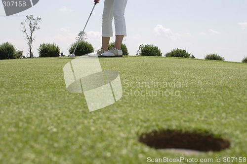 Image of Female golfer playing