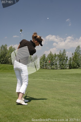 Image of Female golfer playing