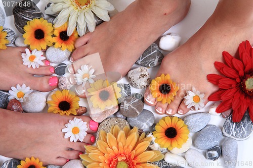 Image of woman feet (pedicure) with stones