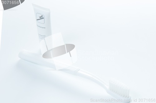 Image of Toothpaste and toothbrush over white