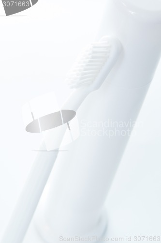 Image of Toothpaste and toothbrush over white