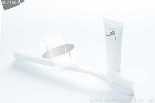 Image of Toothpaste and toothbrush over white