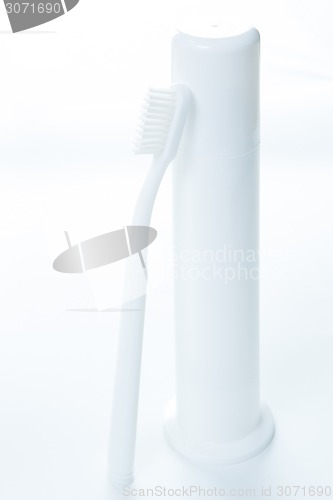 Image of Toothpaste and toothbrush over white