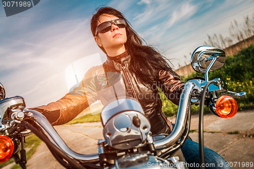 Image of Biker girl on a motorcycle