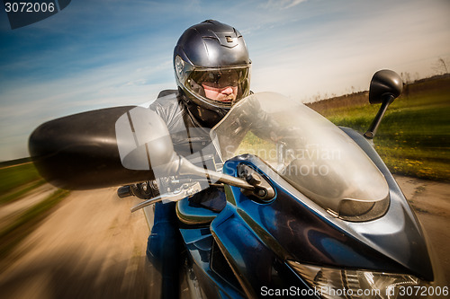 Image of Biker racing on the road