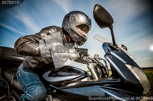 Image of Biker racing on the road