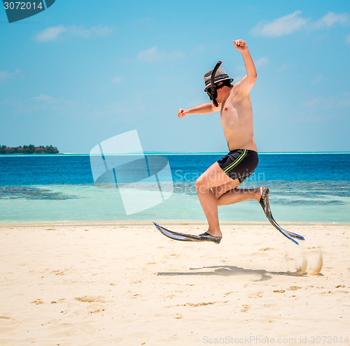 Image of Funny man jumping in flippers and mask.