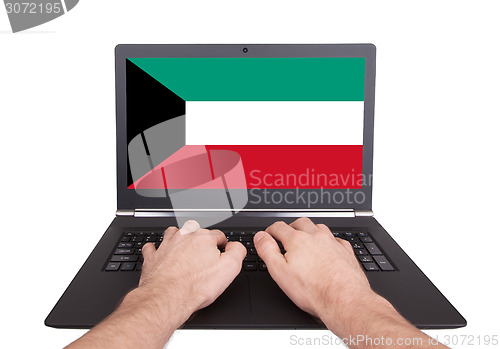 Image of Hands working on laptop, Kuwait