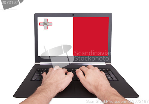 Image of Hands working on laptop, Malta