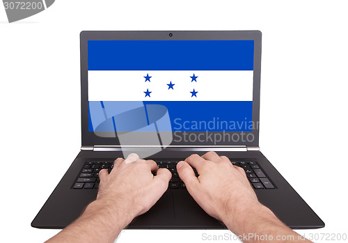 Image of Hands working on laptop, Honduras