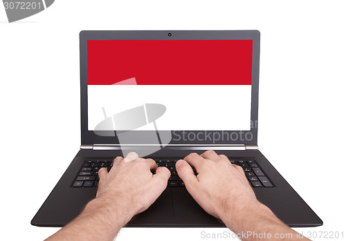 Image of Hands working on laptop, Indonesia