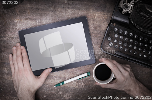 Image of Tablet touch computer gadget on wooden table