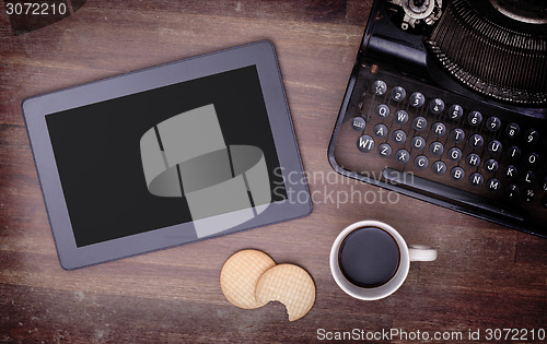 Image of Tablet touch computer gadget on wooden table