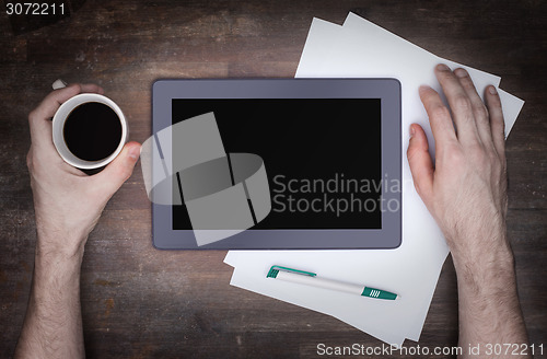 Image of Tablet touch computer gadget on wooden table