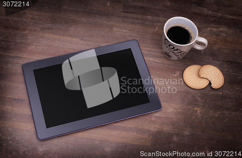 Image of Tablet touch computer gadget on wooden table