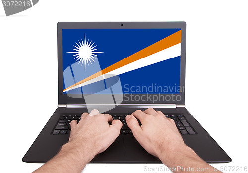 Image of Hands working on laptop, Marshall Islands