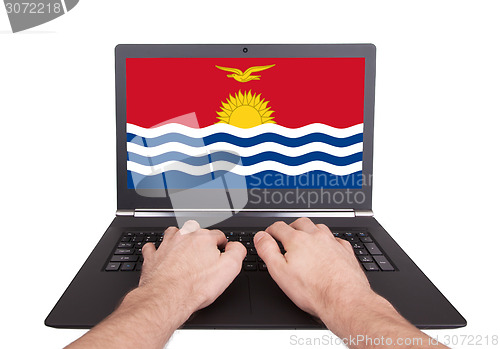 Image of Hands working on laptop, Kiribati