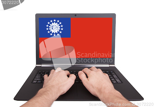 Image of Hands working on laptop, Myanmar