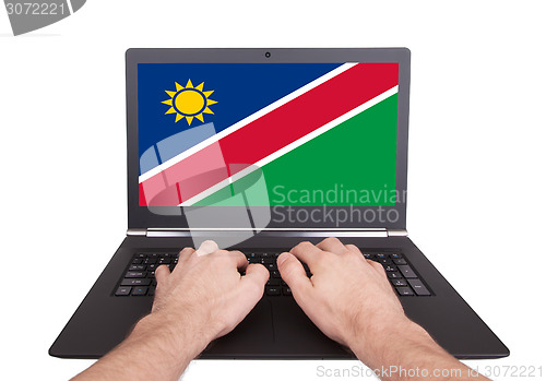 Image of Hands working on laptop, Namibia