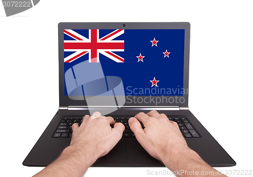 Image of Hands working on laptop, New Zealand