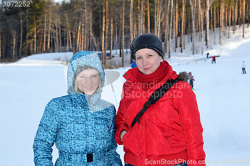 Image of Portrait of two women in winter clothes in the winter outdoors.
