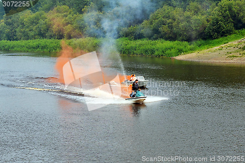 Image of The man on a hydrocycle floats down the river.